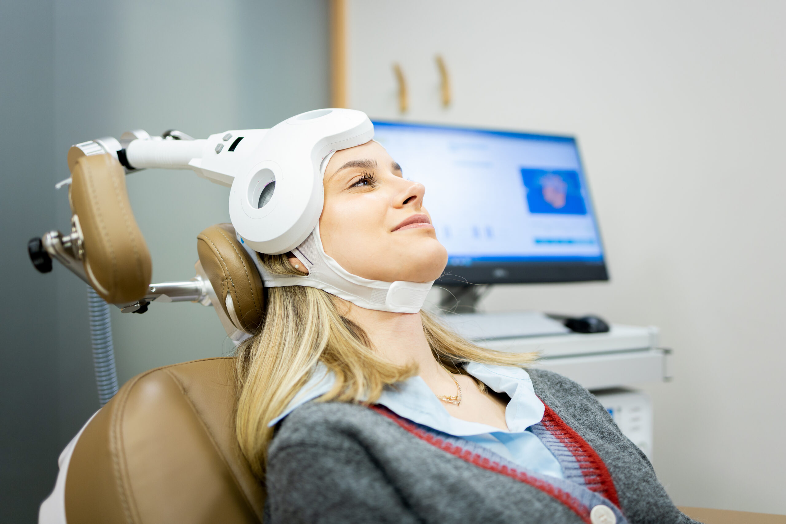 young woman undergoing transcranial magnetic stimulation treatment